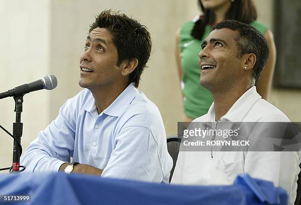 Mexican goalkeeper Jorge Campos and Brazilian soccer star Romario de Souza watch a helicopter go by during their press conference at the Los Angeles...