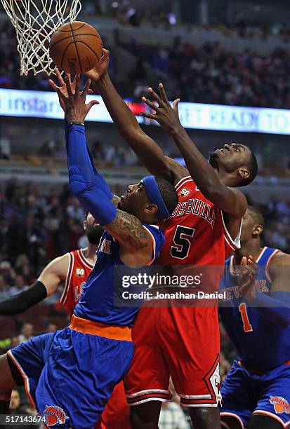 Carmelo Anthony of the New York Knicks and Bobby Portis of the Chicago Bulls battle for a rebound at the United Center on March 23, 2016 in Chicago,...