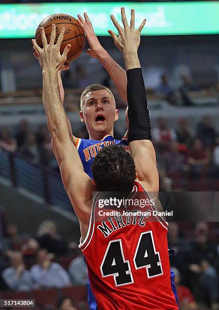 Kristaps Porzingis of the New York Knicks shoots over Nikola Mirotic of the Chicago Bulls at the United Center on March 23, 2016 in Chicago,...