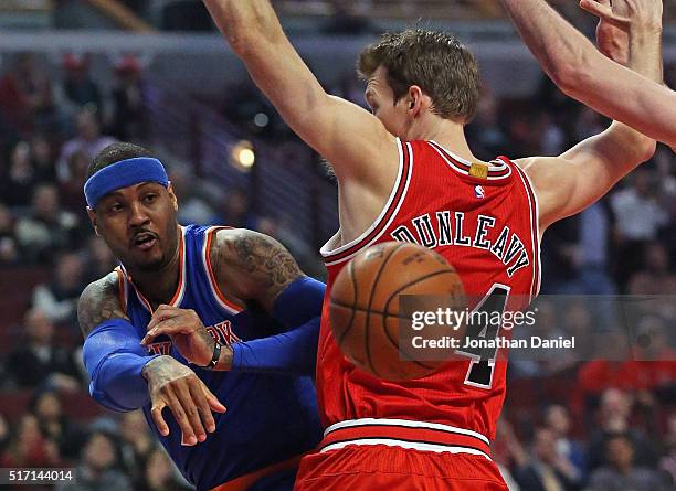 Carmelo Anthony of the New York Knicks passes around Mike Dunleavy of the Chicago Bulls at the United Center on March 23, 2016 in Chicago, Illinois....