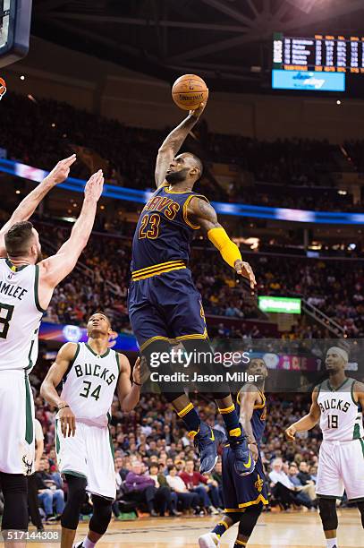 LeBron James of the Cleveland Cavaliers goes up for a dunk over Miles Plumlee of the Milwaukee Bucks during the second half at Quicken Loans Arena on...