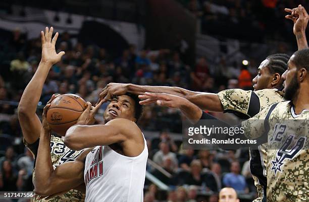 Hassan Whiteside of the Miami Heat has his shot blocked by Kawhi Leonard of the San Antonio Spurs at AT&T Center on March 23, 2016 in San Antonio,...