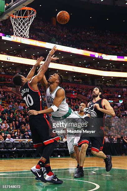 Evan Turner of the Boston Celtics draws a foul from DeMar DeRozan of the Toronto Raptors during the third quarter at TD Garden on March 23, 2016 in...