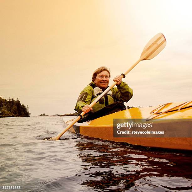 woman kayaking - seniors canoeing stock pictures, royalty-free photos & images