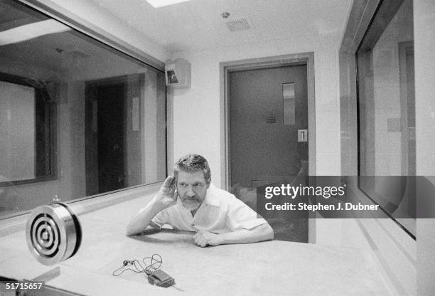 American domestic terrorist, luddite, and mathematics teacher Ted Kaczynski cups his hand to his ear during an interview in a visiting room at the...