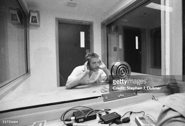 American domestic terrorist, luddite, and mathematics teacher Ted Kaczynski cups both his hands to his ears and listens during an interview in a...