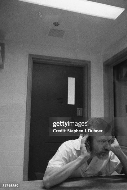 American domestic terrorist, luddite, and mathematics teacher Ted Kaczynski cups both his hands to his ears and listens during an interview in a...