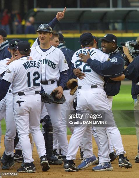 Seattle Mariners' players celebrate their 3-1 ALDS-clinching victory over the Cleveland Indians 15 October 2001 in Seattle, Washington. Relievers...