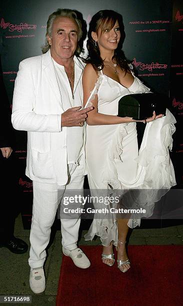 Peter Stringfellow and an unknown female attend a party at lap dancing club Stringfellows to celebrate the launch of its website on November 10, 2004...