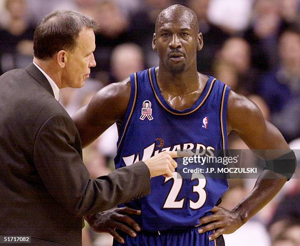 Washington Wizards' Head Coach Doug Collins talks to Michael Jordan during pre-season NBA action against the Toronto Raptors in Toronto, Canada, 25...