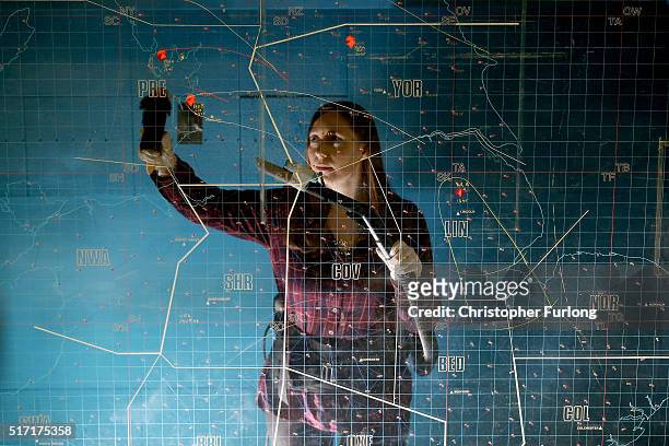 English Heritage site manager Rachael Bowers spring cleans the giant nuclear fallout map at the York Cold War Bunker on February 12, 2016 in York,...