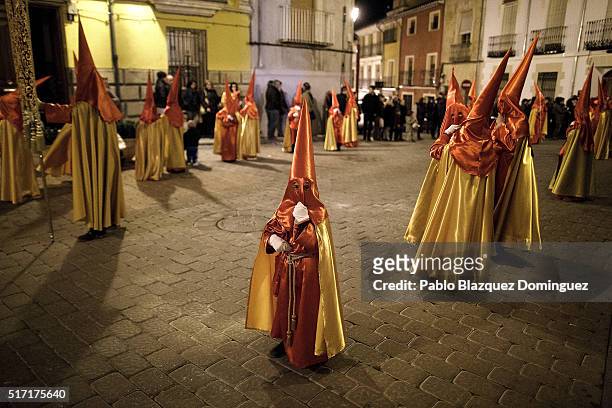Young penitent from 'Santisimo Cristo de la Misericordia' brotherhood looks on at the end of a procession in the early hours on March 24, 2016 in...