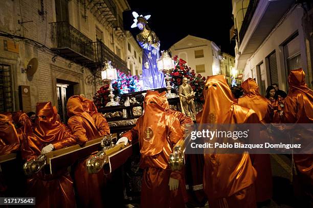 Penitents from 'Santisimo Cristo de la Misericordia' brotherhood take a break as they carry an image of Jesus at the end of a procession in the early...