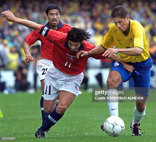 Edilson , of the brasilian soccer team, fights for the ball against Marcelo Salas , of the Chilean team, 07 October 2001in the Couto Pereira in...