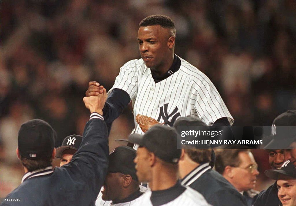 New York Yankees' pitcher Dwight Gooden is carried