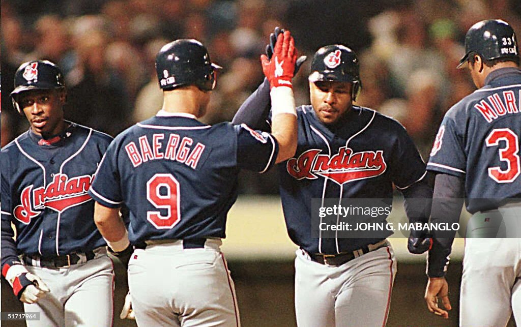 Cleveland Indians Albert Belle (2nd R) is greeted