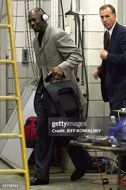 Washington Wizards Michael Jordan arrives with head coach Doug Collins 11 October 2001 at the Palace of Auburn Hills, Michigan, for his first...