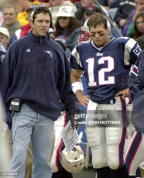 Quarterback Tom Brady stands on the sidelines with injured Quarterback Drew Bledsoe of the New England Patriots during the first quarter of action...