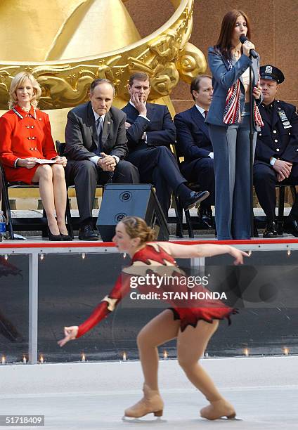 Britain's Prince Andrew watches skater Joanna Glick 15 October at the opening of the ice skating rink at Rockefeller Center in New York as Deborah...