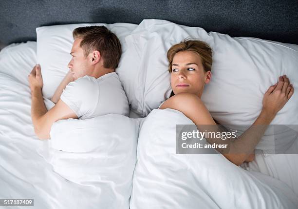 fighting couple sleeping together - tired couple stock pictures, royalty-free photos & images