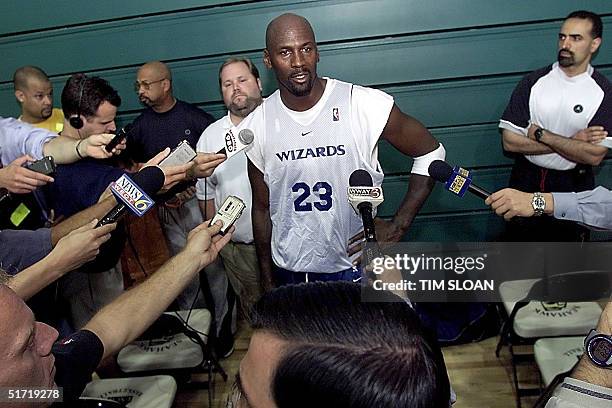 Washingon Wizard Michael Jordan talks briefly with the press after an evening scrimage at the Wizards' training camp 04 October at the University of...