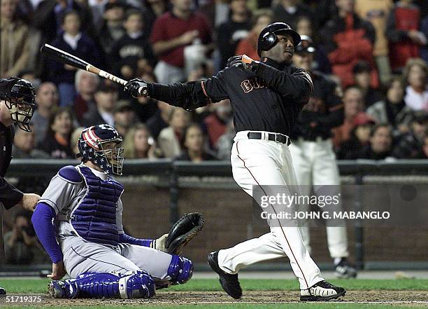 San Francisco Giants slugger Barry Bonds follows through with his record breaking 71st homerun of the season off Los Angeles Dodgers pitcher Chan Ho...