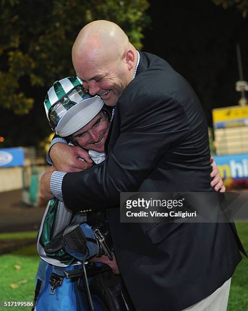 Trainer Peter Moody is embraced by Jockey Luke Nolen after riding Dig A Pony in Race 7, the William Hill Sunline Stakes during Melbourne Racing at...