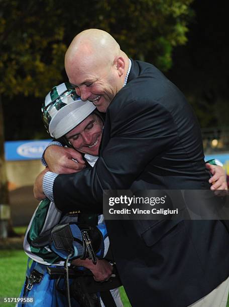 Trainer Peter Moody is embraced by Jockey Luke Nolen after riding Dig A Pony in Race 7, the William Hill Sunline Stakes during Melbourne Racing at...