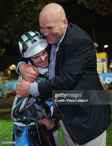 Trainer Peter Moody is embraced by Jockey Luke Nolen after riding Dig A Pony in Race 7, the William Hill Sunline Stakes during Melbourne Racing at...