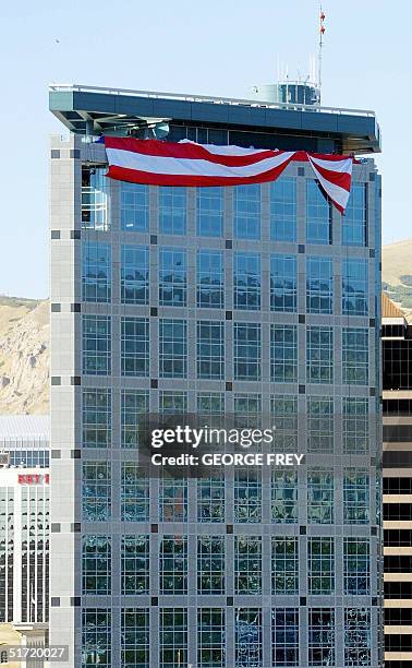 Salt Lake Olympic Committee workers unfold a 180' x 127' American flag on top of the SLOC 24 storey building in downtown Salt Lake City, Utah, 19...