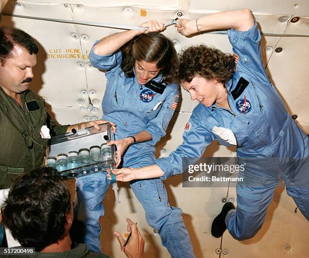 Johnson Space Center, Houston: Sharon Christa McAuliffe, right, and Barbara R. Morgan, participating in the Teacher in Space Project, tem up with Bob...