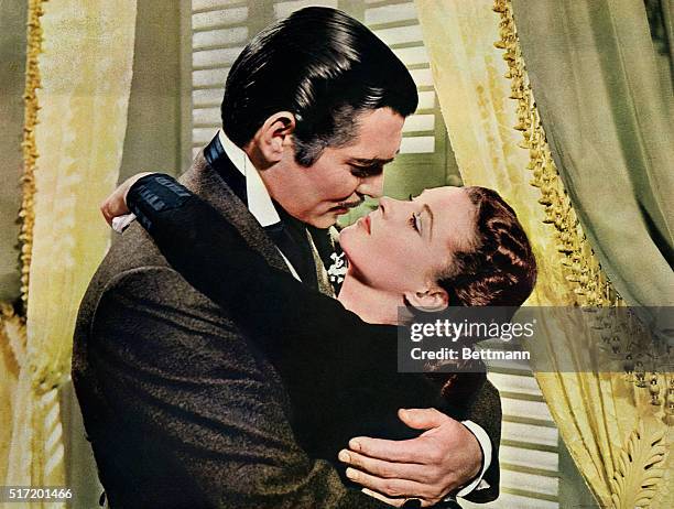 Rhett Butler embraces Scarlett O'Hara in a famous scene from the 1939 epic film Gone with the Wind.