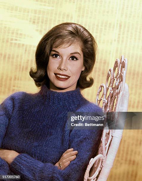 Mary Tyler Moore actress wearing a blue sweater seated in white whicker chair. Head and shoulders publicity still, color slide. Circa 1965.