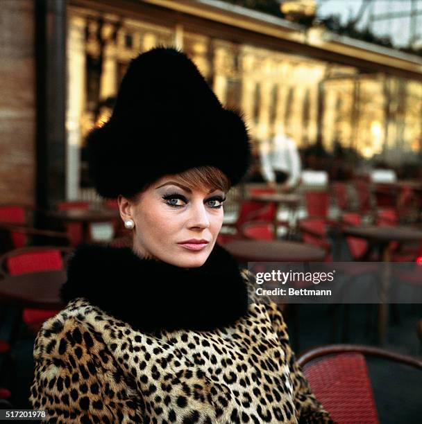 Headshoulders shot of Swedish actress Anita Ekberg , wearing a leopard coat with black fur collar, and black fur hat.