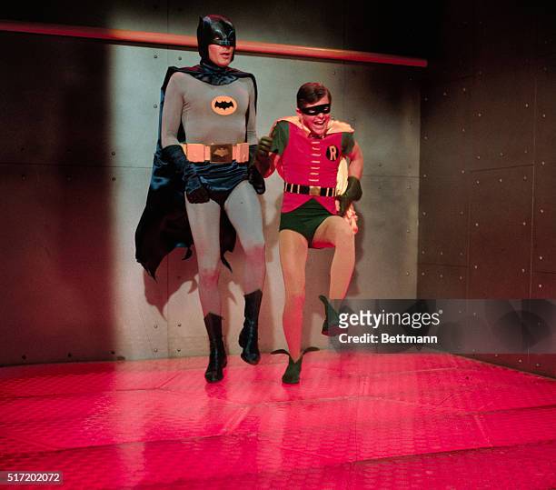 Batman and Robin in a room with a very hot floor. Television handout.