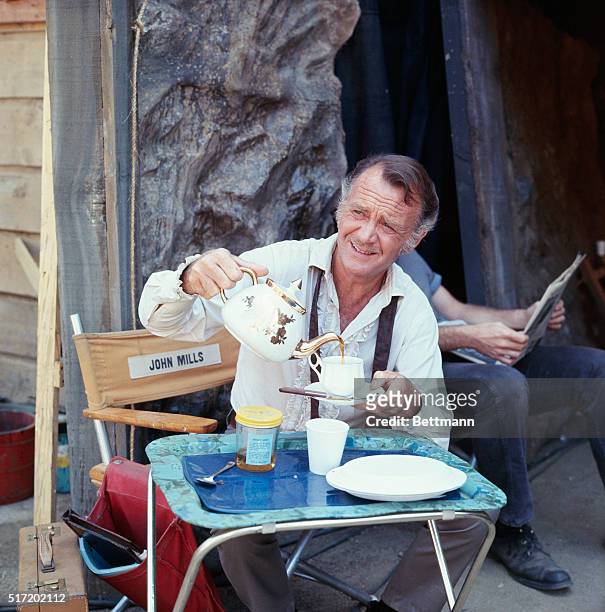 Actor John Mills, star of the short lived TV series, Dundee and the Culhane, on the set of the show having coffee.