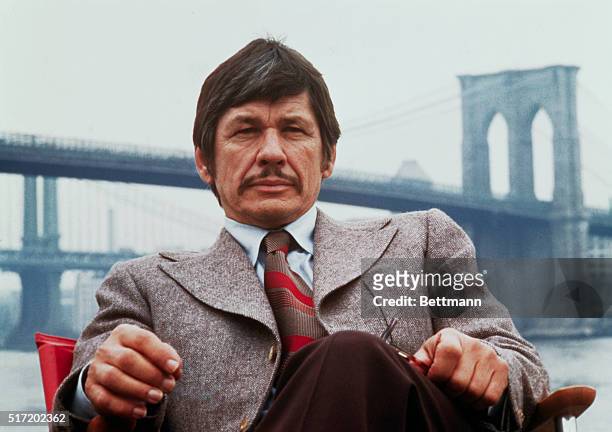 New York, New York: Publicity handout from Death Wish shows Charles Bronson seated on the banks of the East River with the Brooklyn Bridge in the...
