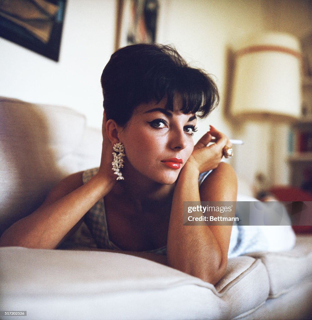 Actress Joan Collins Reclining with Cigarette