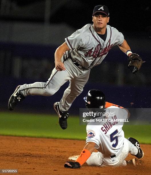 Atlanta Braves second baseman Marcus Giles flys through the air after forcing out Tsuyoshi Shinjo at second and relaying to first for the double play...