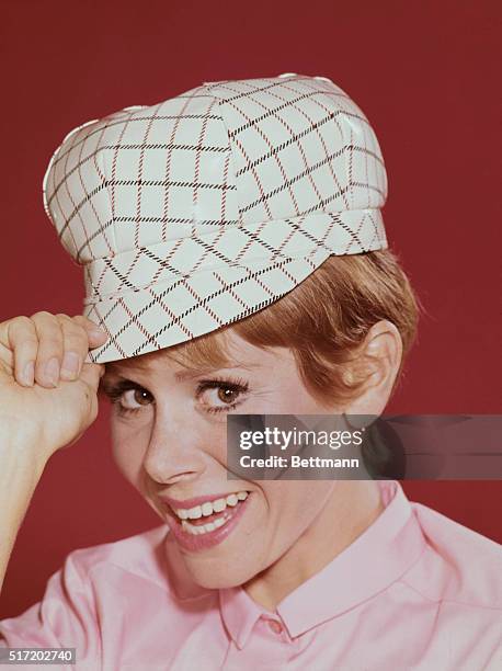 Portrait of actress Judy Carne wearing a white hat.
