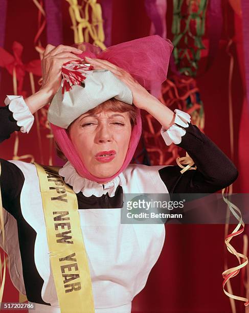 American television and film actress Imogene Coca, clowns around by playing "hungover" in this publicity shot for her short lived TV series Grindl,...