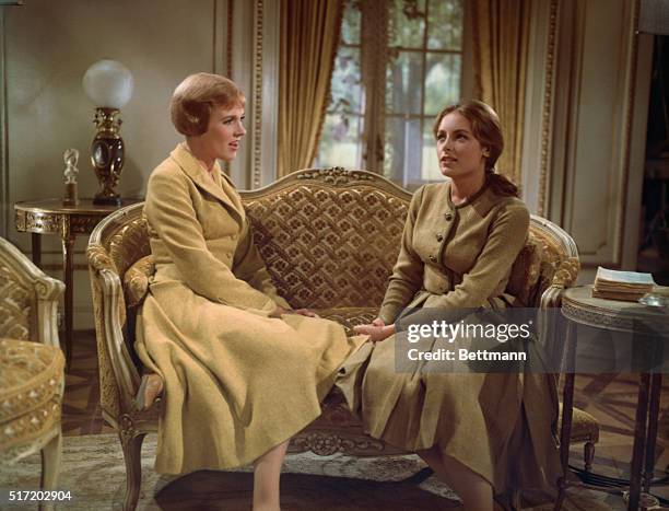 Julie Andrews as Maria von Trapp sits on a sofa with Charmian Carr as Liesl von Trapp in the film adaption of the Rogers and Hammerstein musical The...