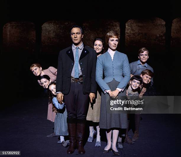 Julie Andrews and Christopher Plummer are flanked on all sides by their children, all members of the singing Von Trapp family, in this publicity...