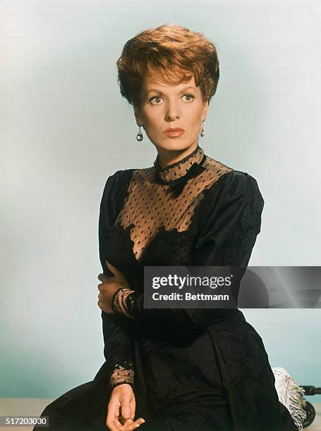 Publicity handout of actress Maureen O'Hara. She is shown from the waist-up wearing a black lace dress, with her had crossed over her other arm.