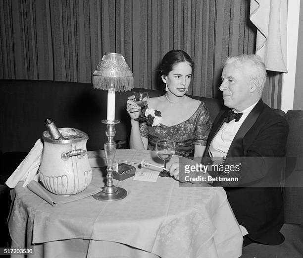 Actor Charlie Chaplin is shown with his wife, actress Oona O'Neill, at the El Morocco nightclub in New York City.