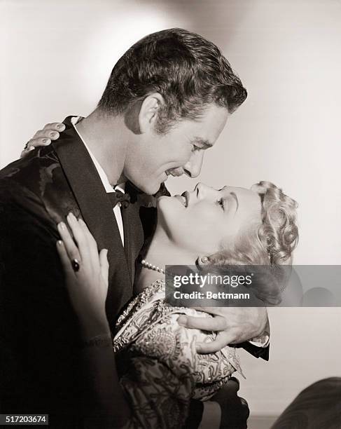 Hollywood: Errol Flynn, swashbuckling hero of the motion picture screen, engages in a passionate love scene with Patrice Wymore during the filming of...