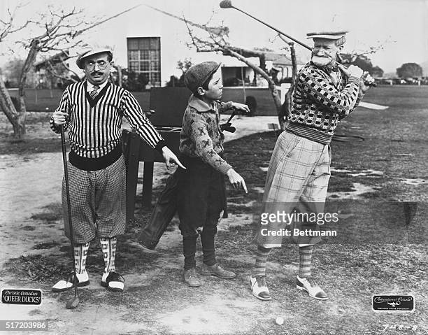 Humorous golf situation from the silent film 'Queer Ducks', starring Jack McHugh as the young caddy and Jack Duffy 1927.