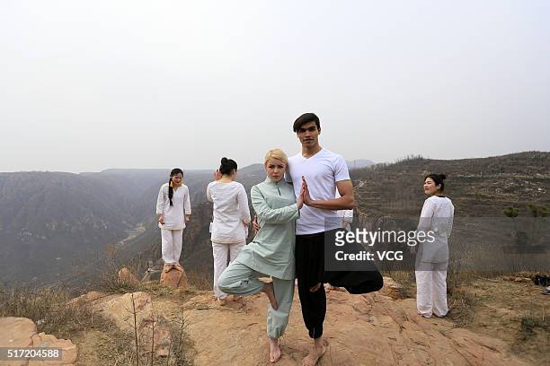 People do yoga on the precipice of Mount Song on March 23, 2016 in Zhengzhou, Henan Province of China. Over 10 yoga enthusiasts practice on the...