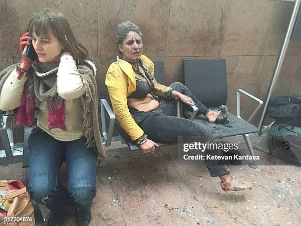 Flight attendant Nidhi Chaphekar reacts in the moments following a suicide bombing at Brussels Zaventem airport on March 22, 2016 in Brussels,...