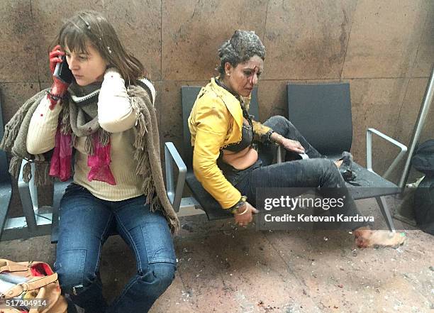 Flight attendant Nidhi Chaphekar reacts in the moments following a suicide bombing at Brussels Zaventem airport on March 22, 2016 in Brussels,...